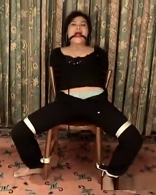 Asian bondage victim bound to a chair