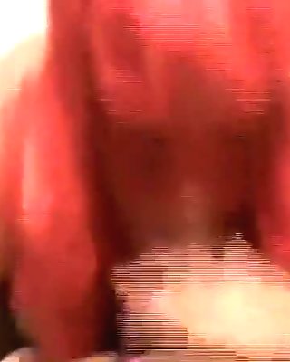 My busty mature wife wearing a red wig and blowing my jock